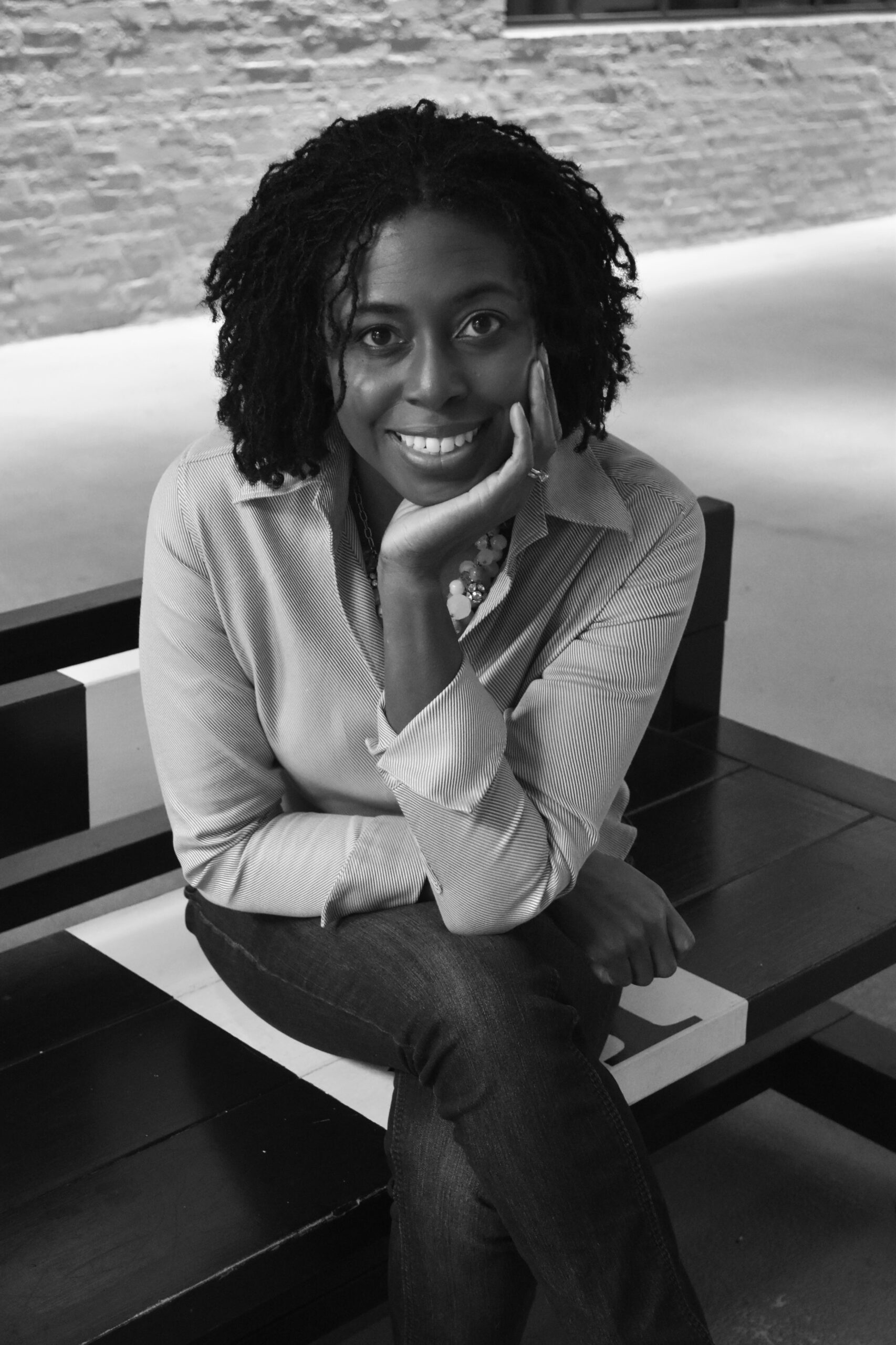 Smiling woman sitting on a wooden bench